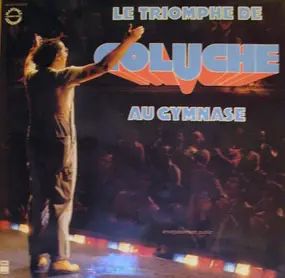 Coluche - Le Triomphe De Coluche Au Gymnase